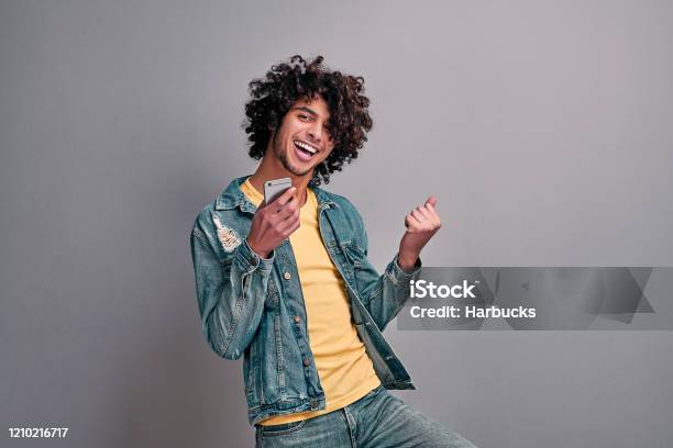 Joyful Student With Phone Stock Photo - Download Image Now - Men, Teenager, Happiness