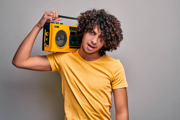 istock Young handsome eastern man with retro tape stereo player 1210216732