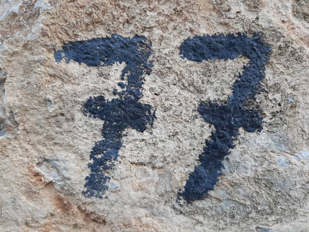 istock Hand painted number, number seventy seven painted on wall 1210218112