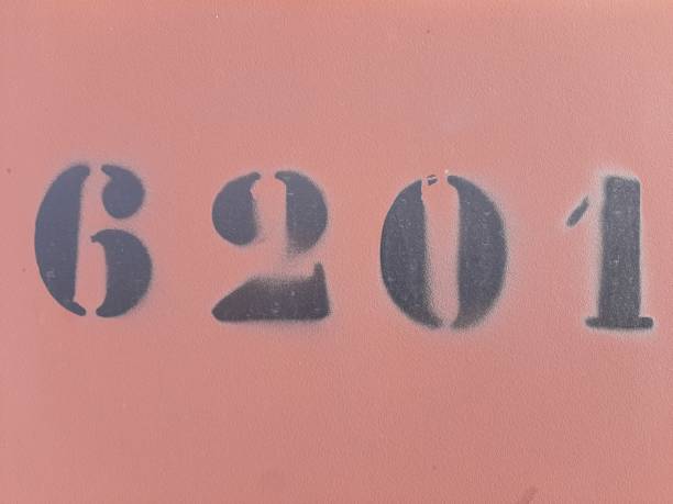 Numbers painted stencil on concrete wall, number 6201