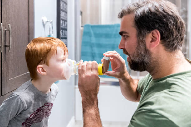 istock Young Boy getting breathing treatment from Father at home 1210219177