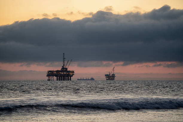 istock Offshore Oil and Gas Fracking and Drilling Rig with the Pacific Ocean in front and a beautiful sunset behind it with dramatic clouds 1210222814
