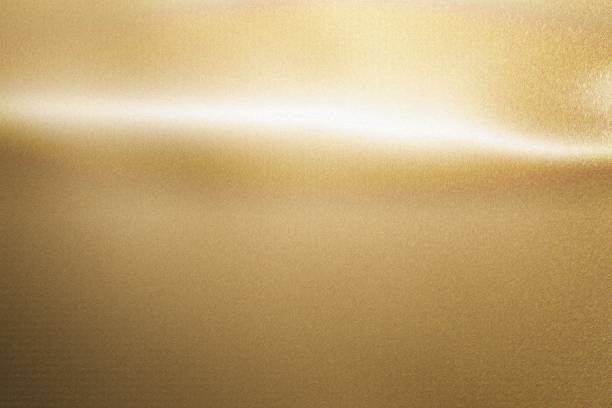 istock Light shining down on gold foil metallic wall with copy space, abstract texture background 1210222989