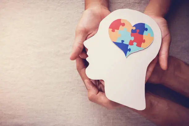 Photo of puzzle jigsaw heart on brain,  mental health concept, world autism awareness day