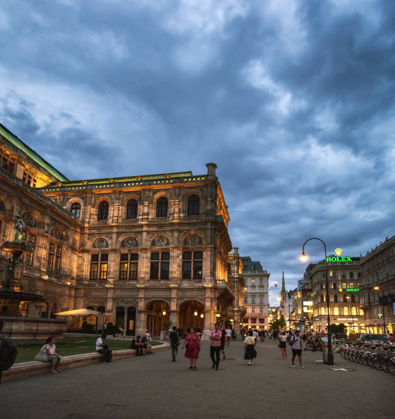 Vienna, Austria - August 19, 2019: Summer evening near State Opera House in Vienna, Austria. People walking and enjoying historic city center of Vienna
