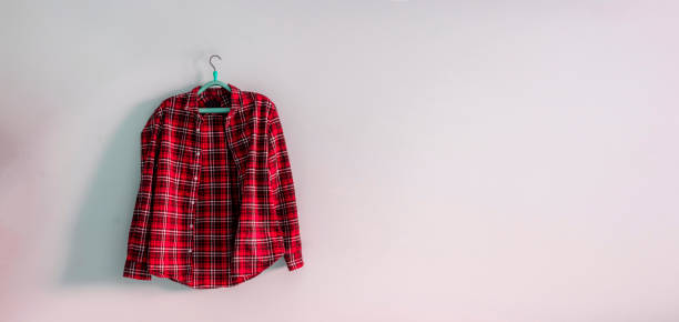 istock a simple checkered shirt on a hanger on a wall, minimalist abstract concept at home 1210232386