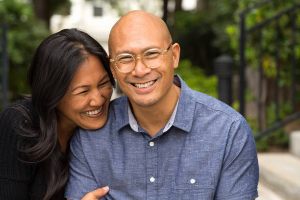 istock Happy Asian couple smiling and hugging outside. 1210233469
