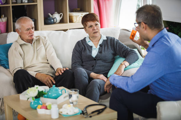istock Elderly couple in informative conversation with their personal doctor 1210234504