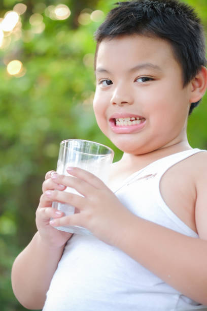 istock Boy drinking water in the morning 1210236806