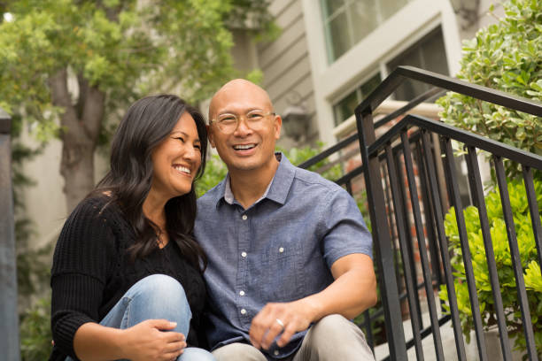 istock Happy Asian couple smiling and hugging outside. 1210237549