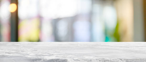 istock Empty white marble stone table top and blur glass window interior restaurant banner mock up abstract background - can used for display or montage your products. 1210249542