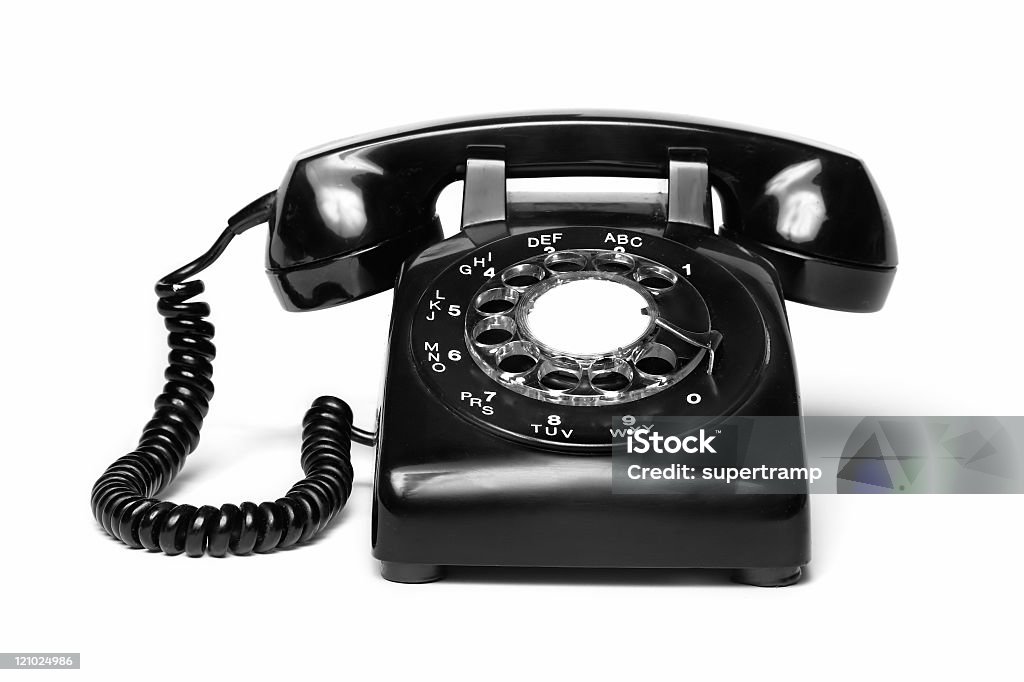 An antique black telephone on a white background  1960s style antique black telephone isolated on white Telephone Stock Photo