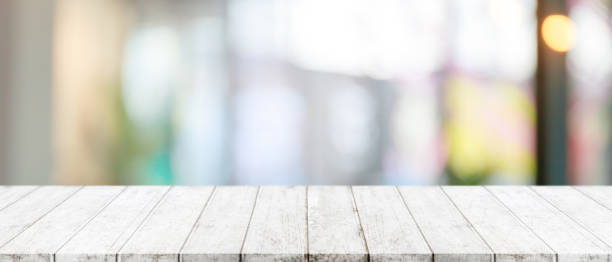 istock Empty wood table top and blurred of window interior restaurant banner mock up abstract background - can used for display or montage your products. 1210251900