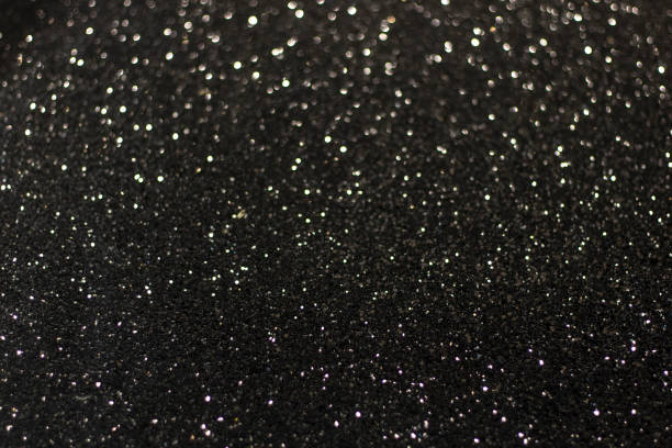 istock Black surface with white glare and bokeh. Black and white texture background. Blurred edges. 1210252910