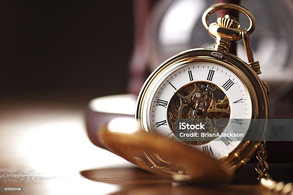 Gold pocket watch and hourglass Vintage pocket watch and hour glass or sand timer, symbols of time with copy space Antique Stock Photo