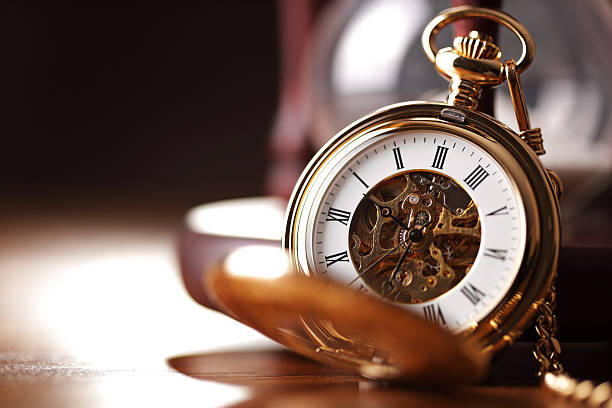 Gold pocket watch and hourglass Vintage pocket watch and hour glass or sand timer, symbols of time with copy space watch timepiece photos stock pictures, royalty-free photos & images