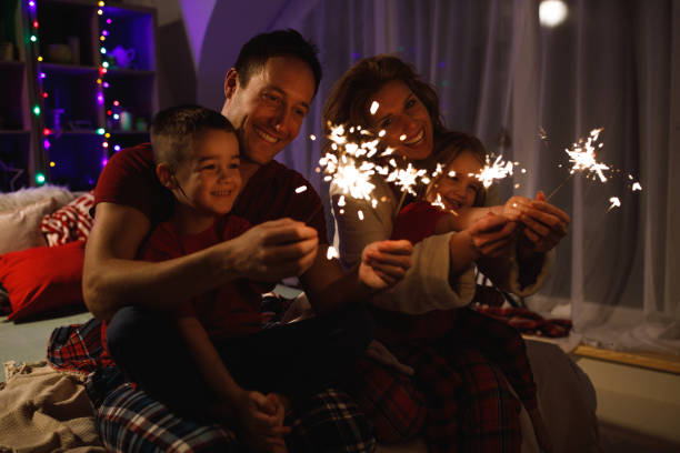 istock Family having fun with Christmas sprinklers 1210255866