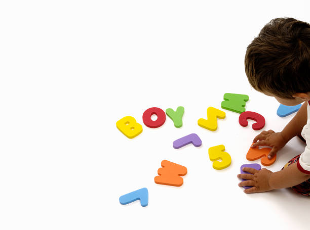 istock Little boy learning letters and numbers on white 121025669
