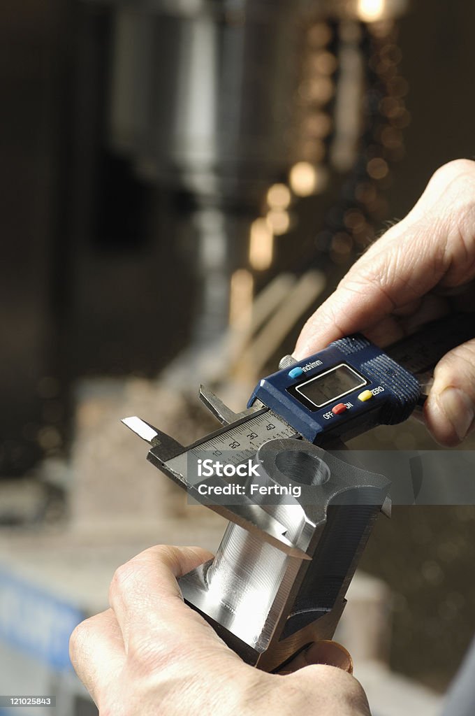 Milling machine operator checking measurements  Quality Control Stock Photo