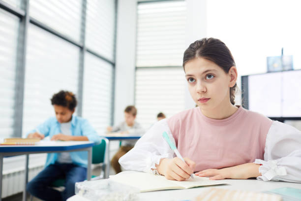 istock Attentive Girl Working In Class 1210258547