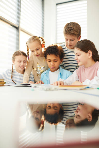 istock Children Helping Friend With Homework 1210259407