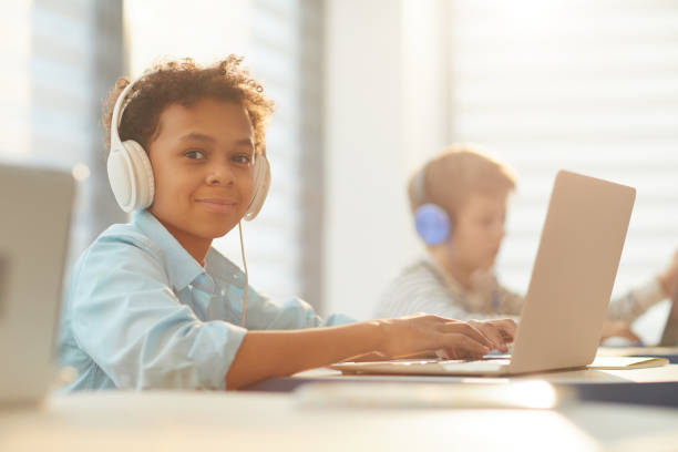 istock Boy In Headphones At School 1210259612