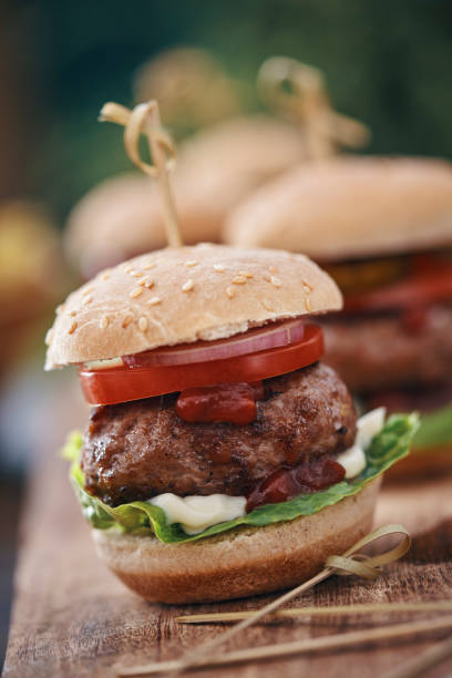 istock Mini Burgers with Tomato, Onion and Lettuce 1210259712