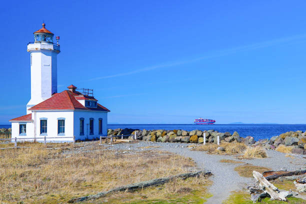istock Cargo Ship at Point Wilson Lighthouse, Port Townsend, Washington 1210259735