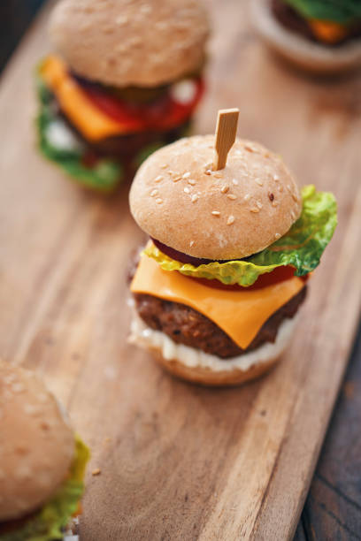 istock Mini Burgers with Tomato, Onion and Lettuce 1210260301