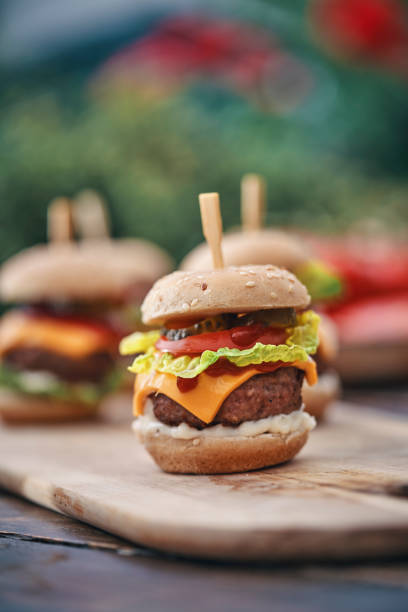 istock Mini Burgers with Tomato, Onion and Lettuce 1210260341