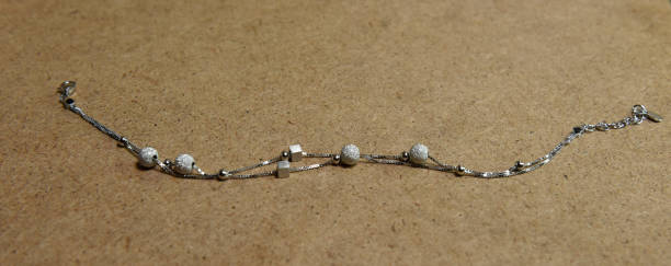 istock traditional silver anklet on wooden background 1210264163
