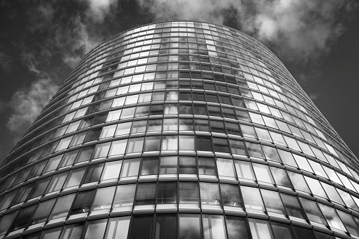 Looking up at a modern office building in Duesseldorf, high contrast black and white photograph.