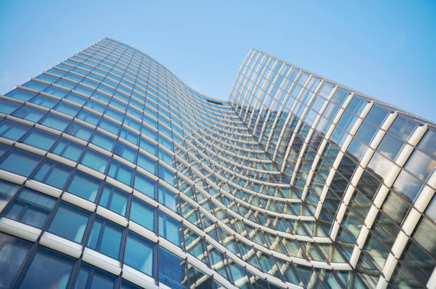Low angle view of a modern office building, steel and glass business background.