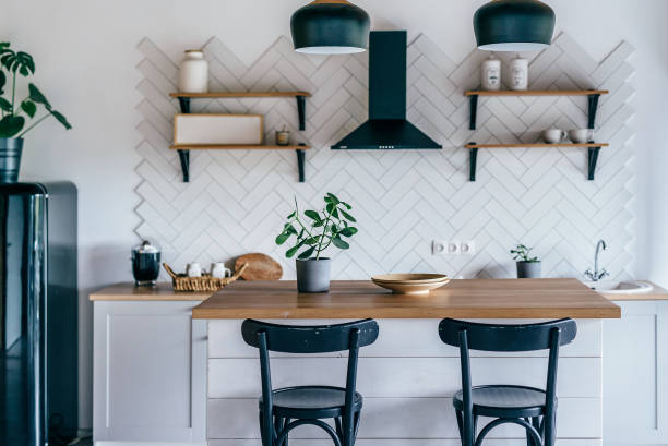 istock Modern new light interior of kitchen with white furniture and dining table. 1210264554