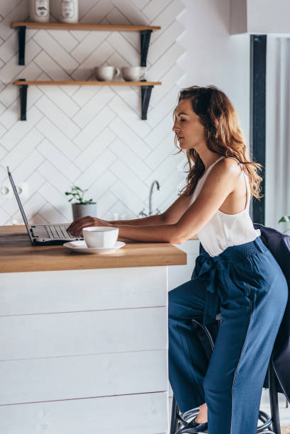 istock Woman using laptop while sitting at home. 1210264556