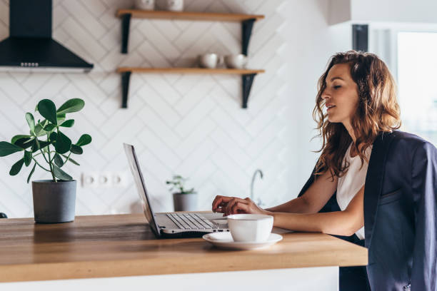 istock Young woman sitting in front open laptop and working at home 1210264569