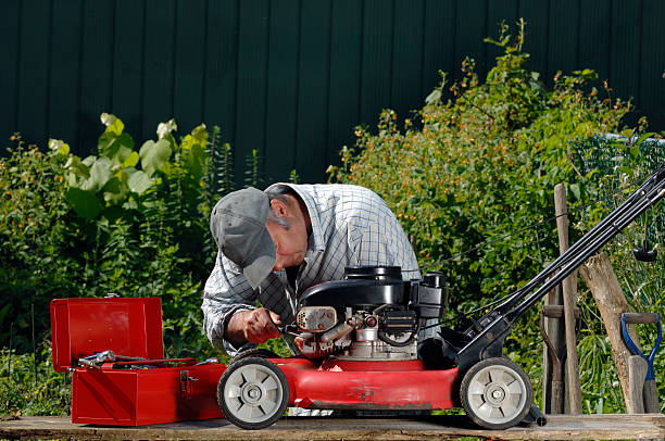 Man working on a lawnmower stock photo