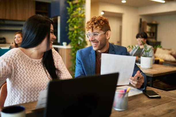 istock Relaxed Business Partners Talking in Coworking Office Space 1210265597