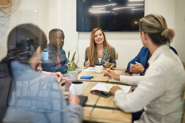istock Young Business Team Discussing Ideas in Small Board Room 1210265612