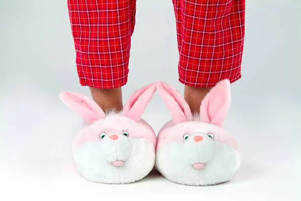 Photo of Man's legs in bunny slippers
