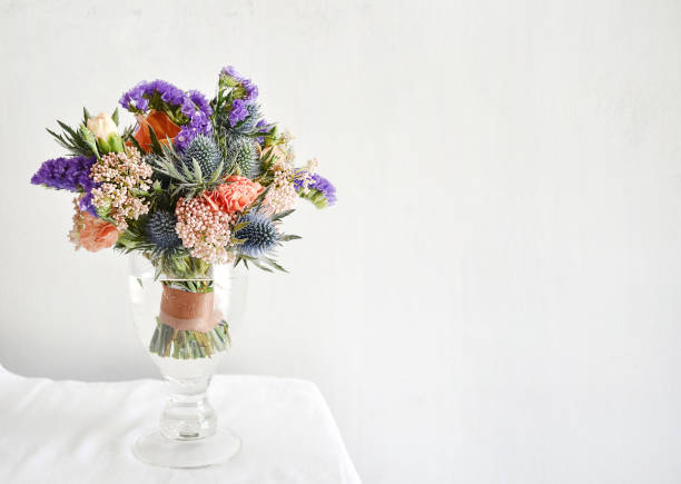 istock Beautiful flower in a glass vase on table 1210266853