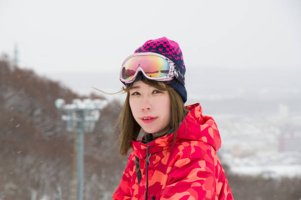 Ski resort Ski slopes with snow and female skiers japanese snowboarder stock pictures, royalty-free photos & images