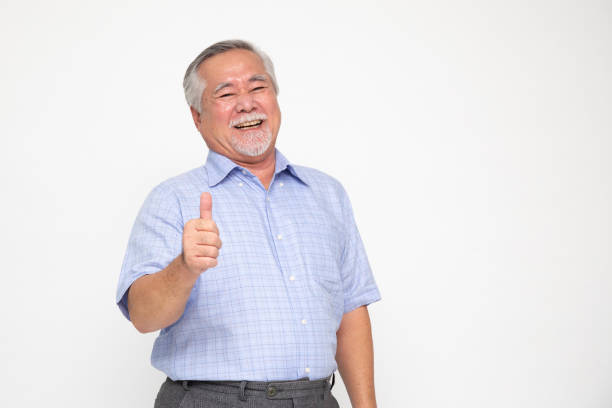 cheerful-asian-senior-man-giving-a-thumb-up-and-looking-at-the-camera-isolated-on-white.jpg