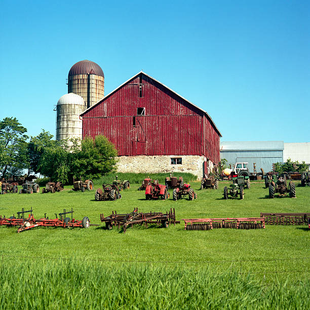 istock Barn with antique farm equipment 121026825
