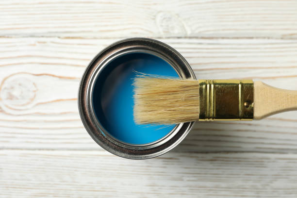 istock Paint can and brush on wooden background, top view 1210269220