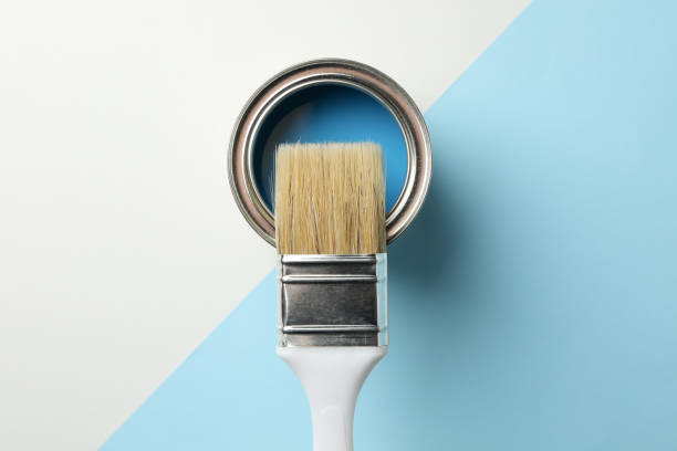 istock Paint can and brush on two tone background, top view 1210269255