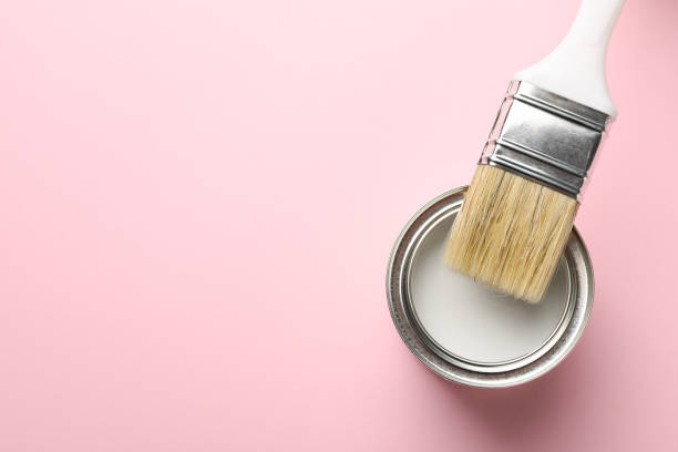 istock Paint can and brush on pink background, top view 1210269990