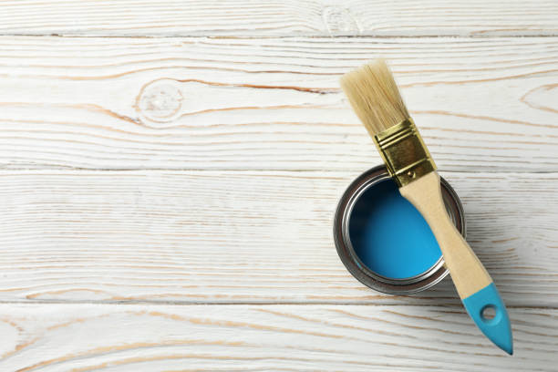 istock Paint can and brush on wooden background, top view 1210270827