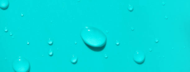 istock Close-up water drops on turquoise colored background, top view. Banner format backdrop 1210271360