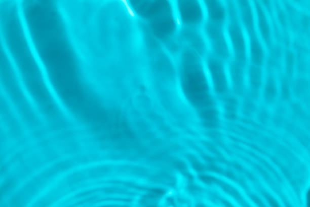istock Water background. Bright blue liquid ripple sea texture. Summer swimming pool surface backdrop, top view 1210271764